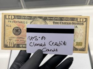 USA clone card with $10 bill in hand – high limit cloned credit card for ATM withdrawals in New York, Los Angeles, Chicago, and across all 50 states