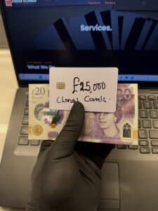 Single UK cloned card with £15,000 balance held in hand with £20 bills – high limit clone card for ATM use in London, Manchester, and across the UK