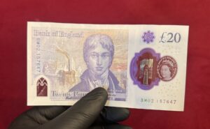 Backside of fake £20 pound note showing realistic counterfeit GBP features including the bridge and security elements